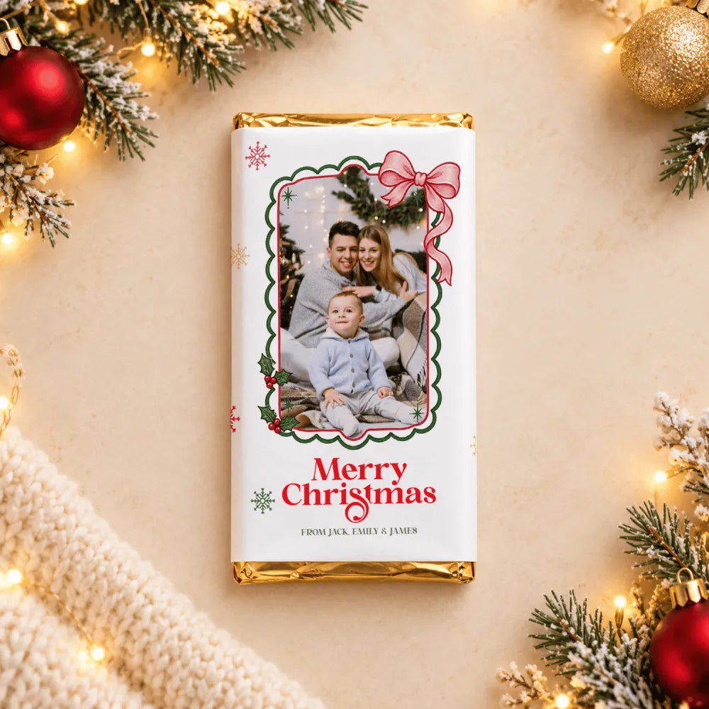 A personalized white chocolate bar with a gold foil wrapper featuring a festive family christmas photo chocolate wrap