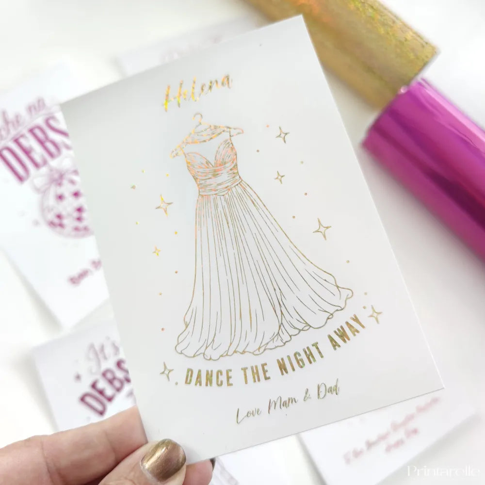A white debs night card with a gold foil strapless gown and dance the night away in blue foil lettering