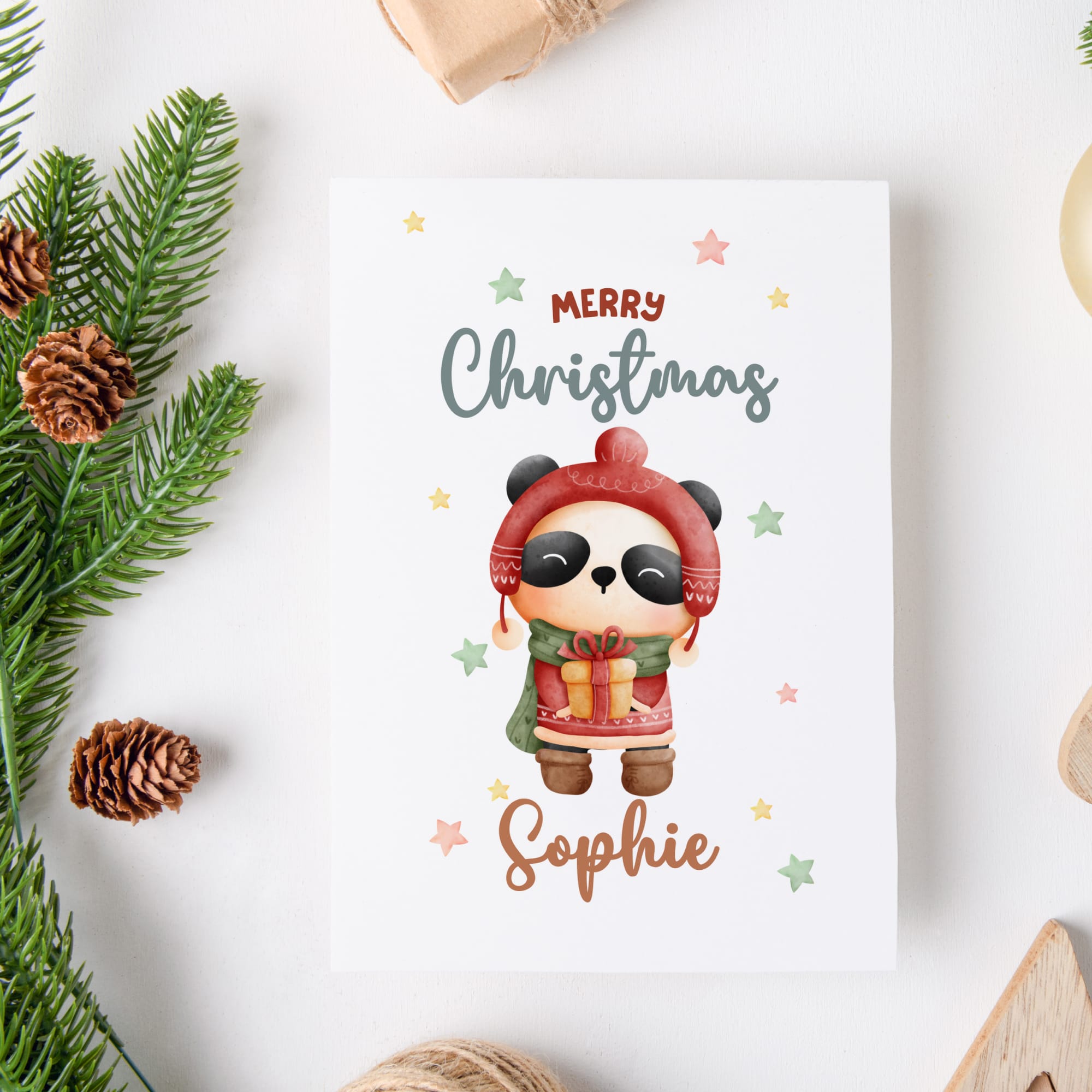 Christmas card with a panda character and 'Merry Christmas Sophie' text, surrounded by festive decorations.