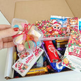 A clear plastic star container filled with colorful hard candies tied with a red string for late late toy sweet box