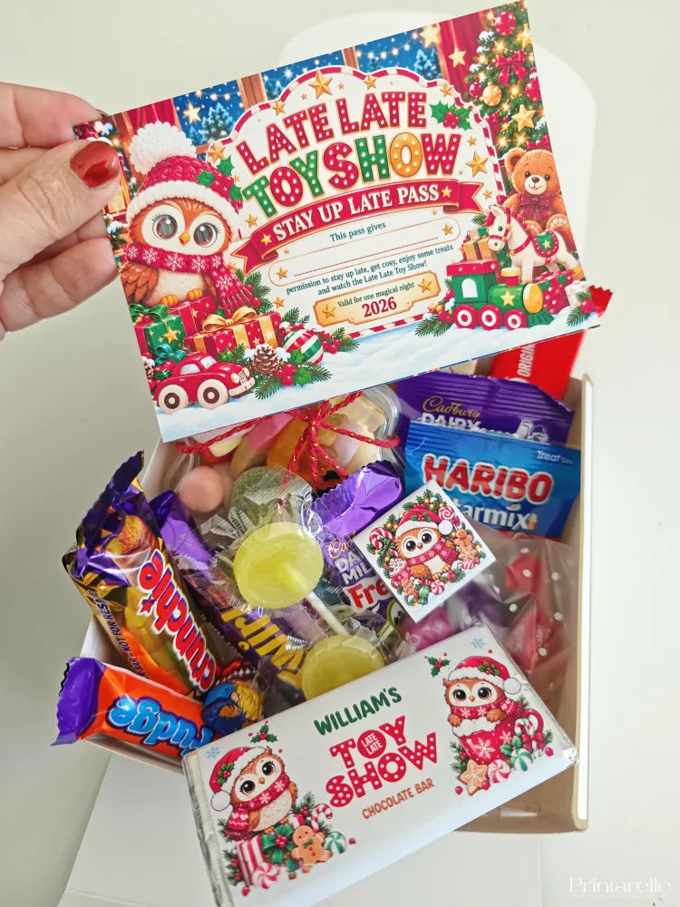 A festive red and white late late toy stay up late pass card with a santa owl and christmas decorations in sweet box
