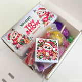 A festive white chocolate late late toy bar with a cartoon owl santa surrounded by holiday treats