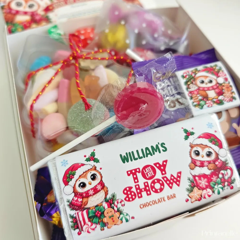 A festive white chocolate bar with a cartoon owl in santa hat from the late late toy show sweet box