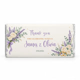 A personalised 40g chocolate bar wrapped in silver foil with an ivory roses label for weddings and thank you gifts