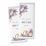 Two personalised 40g chocolate bars wrapped in clear foil with purple lavender floral design and wedding details sinead & tadhg
