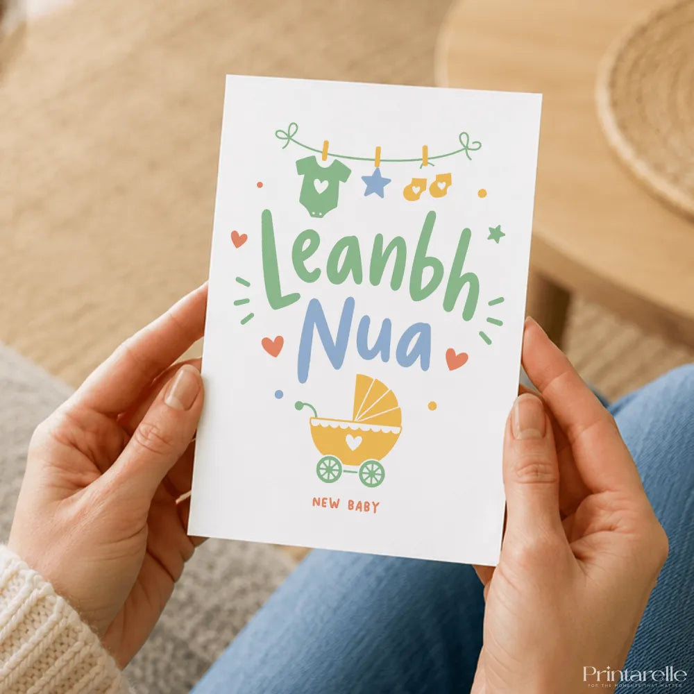 A white leanbh nua baby card with colorful baby clothes, stroller illustrations, soft green text, perfect for new baby gifts