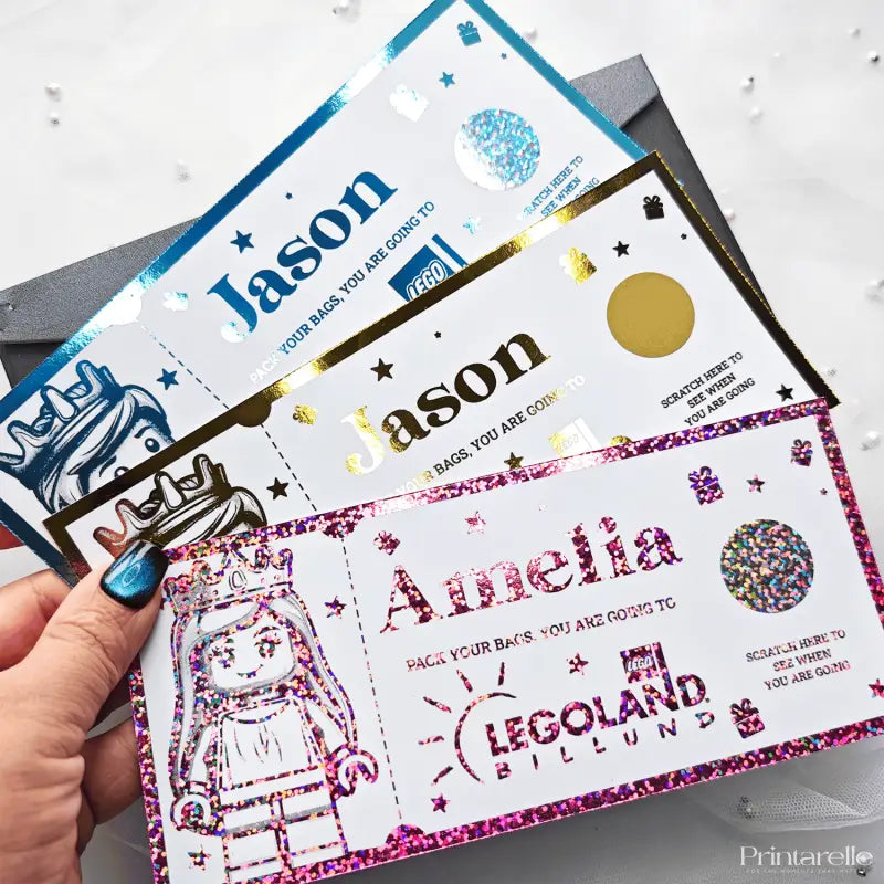 Personalized name tags with glittery designs and 'Legoland Billund' branding.