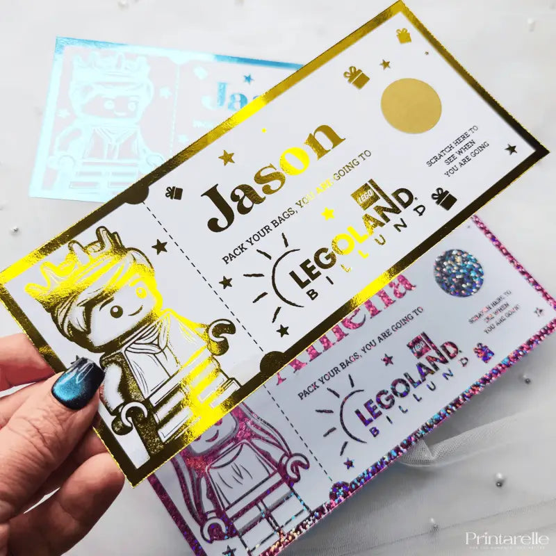 Colorful ticket with 'Jason' and 'Legoland' text, held by a hand.