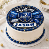 A round leinster rugby birthday cake with white frosting blue and gold piping and an edible icing sheet cake topper