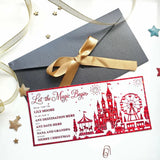Red laser cut reveal card with castle ferris wheel and carousel silhouettes to let the magic begin christmas surprise
