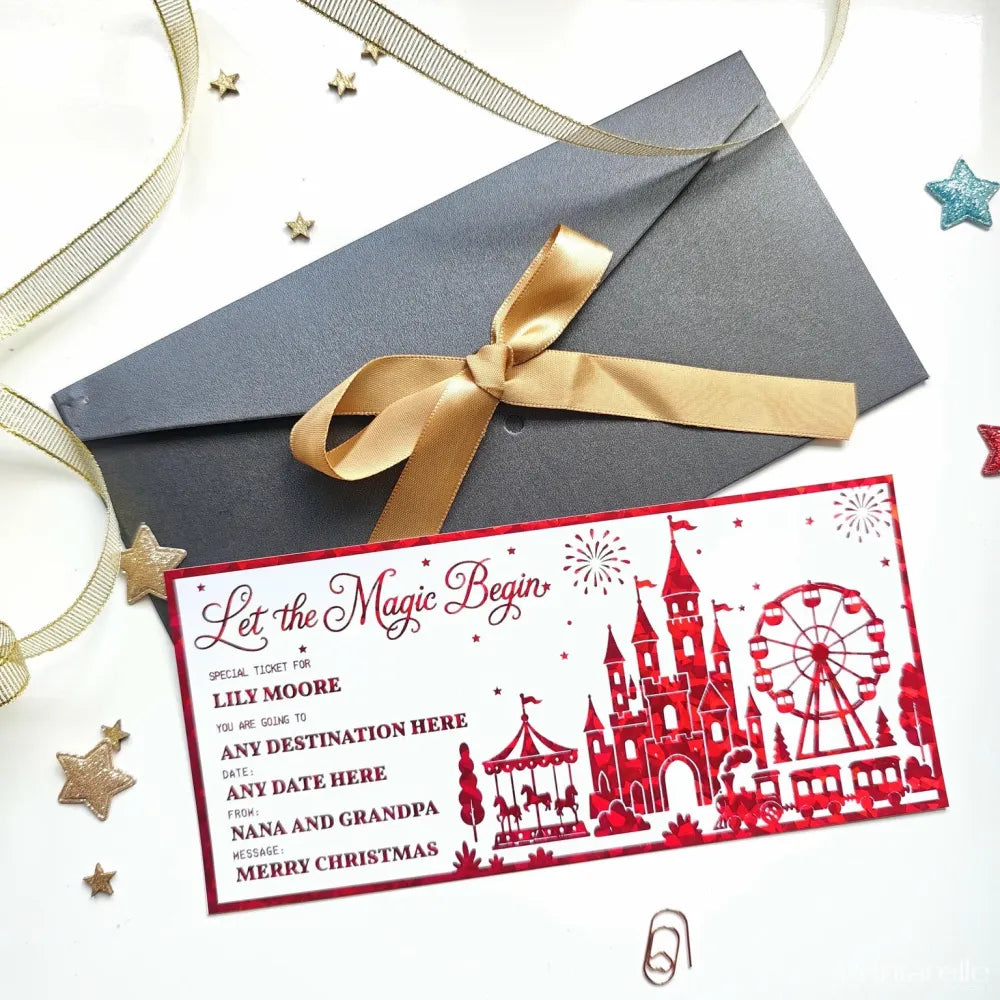Red laser cut reveal card with castle ferris wheel and carousel silhouettes to let the magic begin christmas surprise
