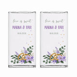 Two personalised 40g chocolate bars wrapped in silver foil with lilac rings wedding label and gold floral design