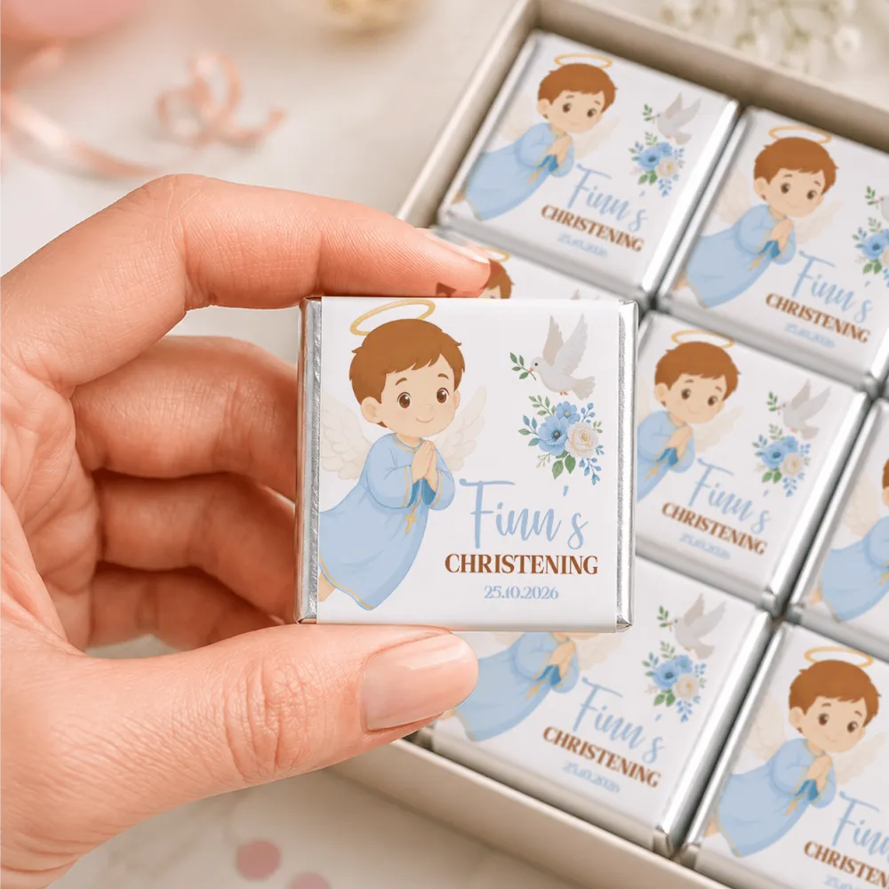 A hand holds a silver wrapped little angel boy christening mini neapolitans chocolate bar with a cartoon angel design