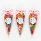 Three clear plastic sweet cones filled with colorful gummies, pink ribbons, angel boy christening sweet cones labels