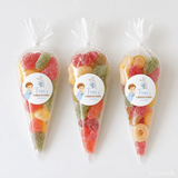 Three clear plastic sweet cones filled with colorful sugared gummy candies for little angel boy christening sweet gifts