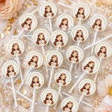 White lollipop wrapped in clear plastic with a cartoon girl wearing a flower crown and an 8cm sticker from little angel confirmation lollipop favours