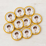 Circular yellow-edged confirmation chocolate coins featuring a smiling boy with a golden chalice for finn’s day