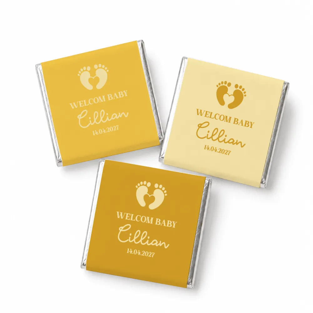 Personalized yellow and cream foil-wrapped mini neapolitan chocolates with gold footprints and welcome baby cillian text