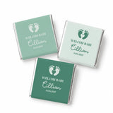Three mint green and teal foil-wrapped mini neapolitan chocolates with welcome baby footprints design perfect baby favours