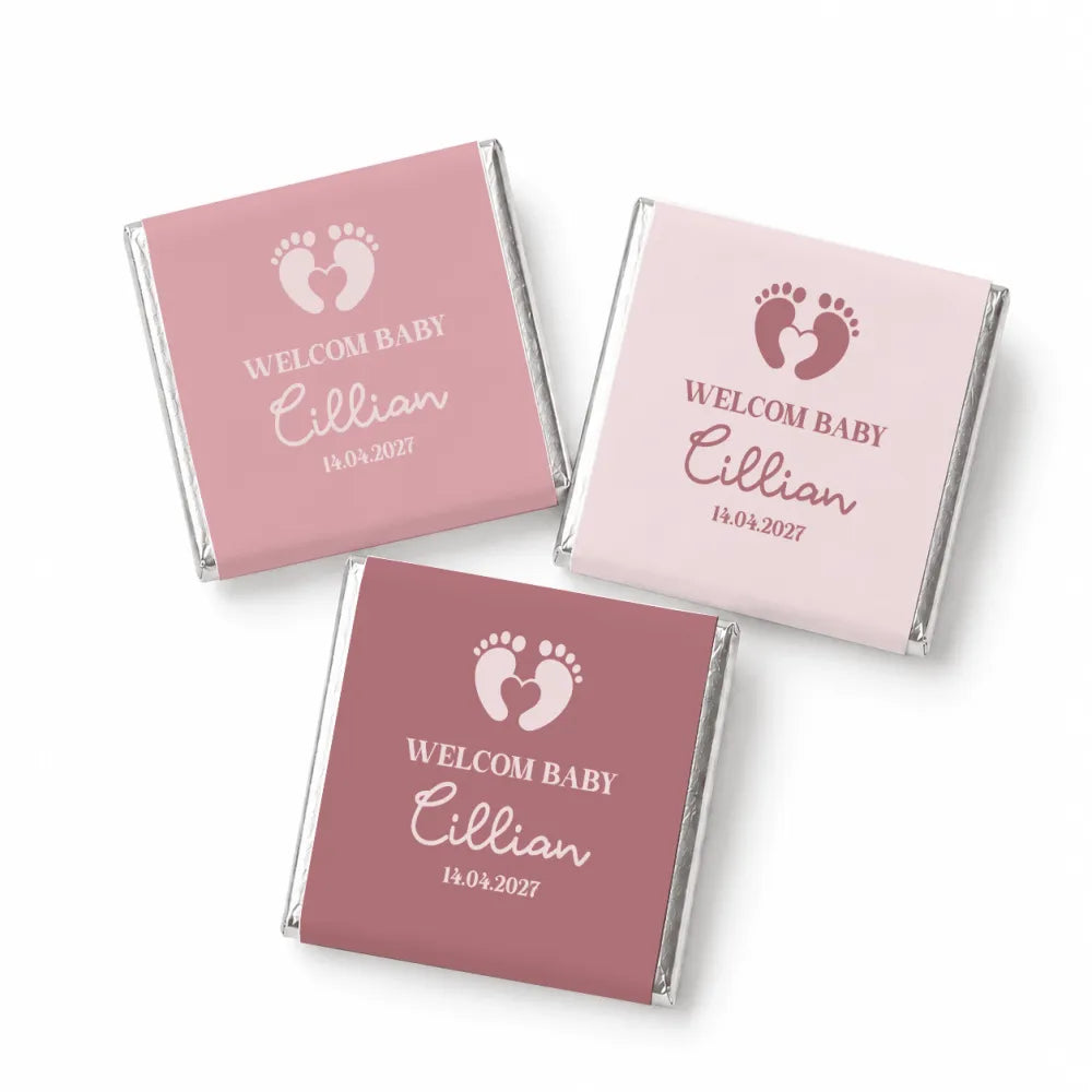 Pink and mauve mini neapolitan chocolates wrapped with silver foil edges featuring baby footprints and welcome baby cillian text