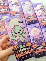 A halloween chocolate wrap in purple and black with a cute green zombie, pumpkins, and bats for little ghouls