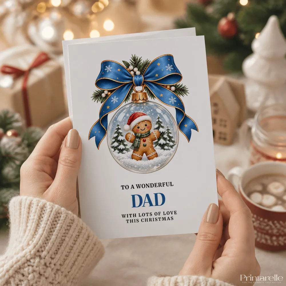A white dad christmas card featuring a gingerbread dad inside a glass bauble snow globe with blue ribbon bow