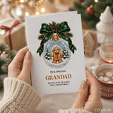White christmas card with green ribbon bow featuring a gingerbread grandad ornament wearing round glasses and bow tie in gold lettering