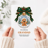 A festive white grandad christmas card with a glass gingerbread bauble wearing round glasses and a green bow tie