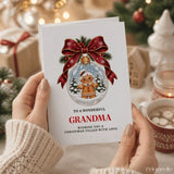 A white grandma christmas card featuring a gingerbread grandma in a snow globe with pine trees and red ribbon bow