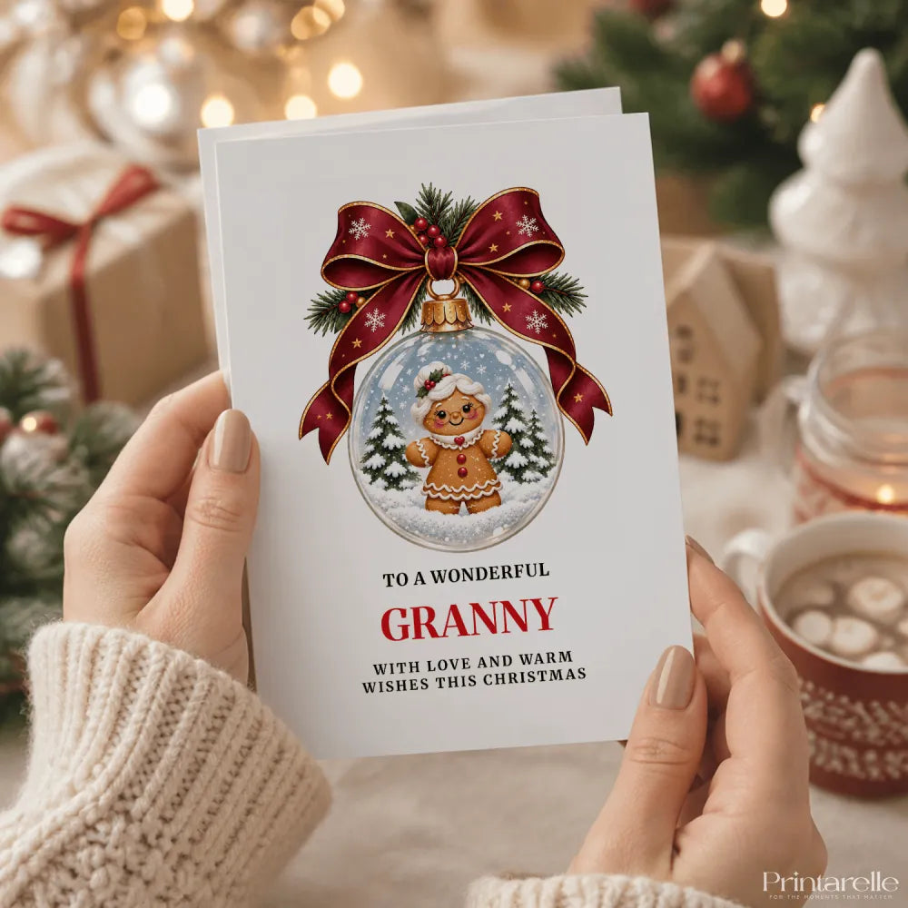 White granny christmas card featuring a gingerbread granny in a glass bauble with red bow and pine sprigs