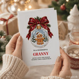 White granny christmas card featuring a gingerbread granny in a glass bauble with red bow and pine sprigs