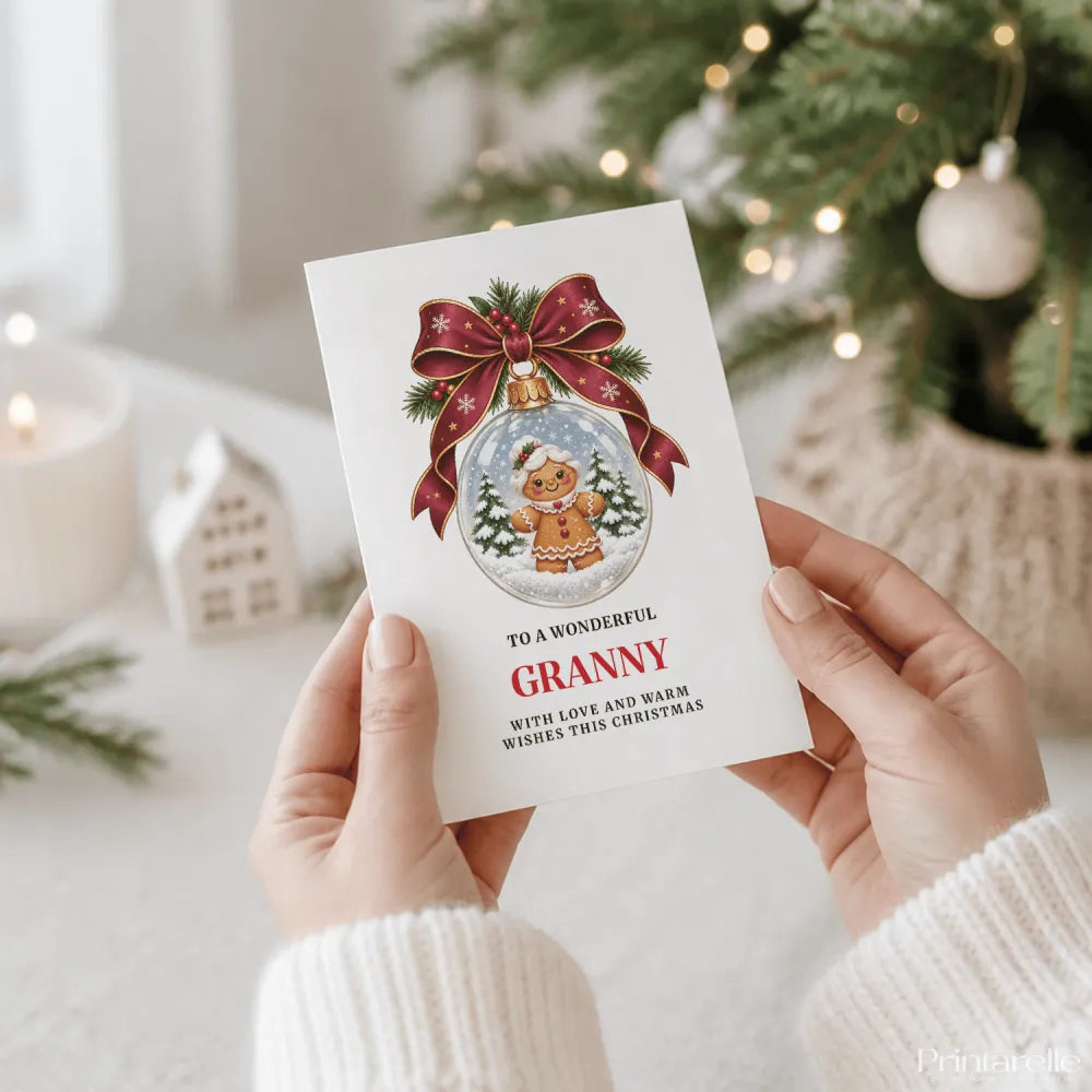 A white granny christmas card featuring a gingerbread granny inside a glass bauble with red ribbon and pine sprigs
