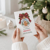 A white granny christmas card featuring a gingerbread granny inside a glass bauble with red ribbon and pine sprigs