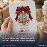 A festive white granny christmas card featuring a gingerbread granny inside a glass bauble with red ribbon and pine sprigs