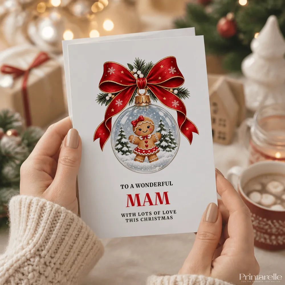 A festive white mam christmas card featuring a gingerbread girl in a red dress inside a snow globe with a red bow