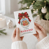 A festive white christmas card with a red ribbon and gingerbread couple snow globe for mam and dad christmas card