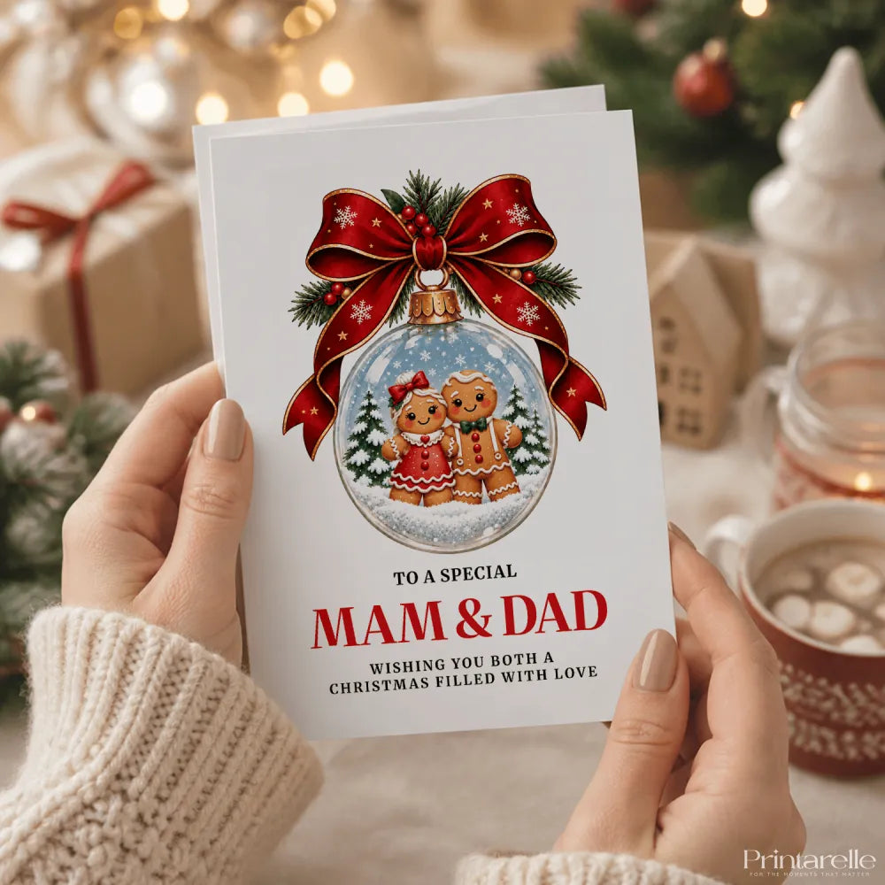 A festive white christmas card with red ribbon bow and gingerbread couple snow globe addressed to mam and dad dad christmas card