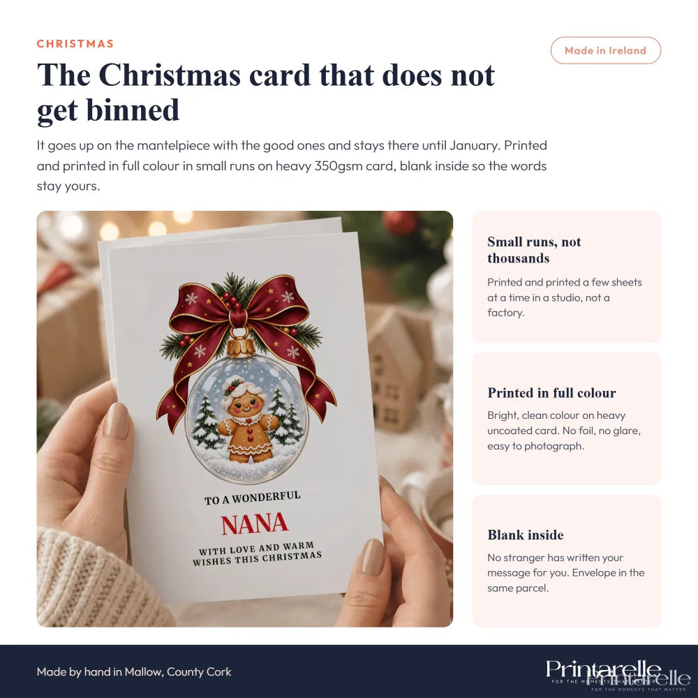 A festive nana christmas card featuring a gingerbread man snow globe with red ribbon and greenery heart brooch design