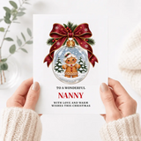 A festive nanny christmas card featuring a gingerbread nanny inside a clear glass bauble with red ribbon and greenery