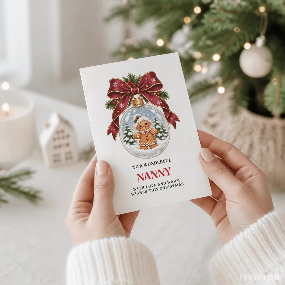 A white nanny christmas card featuring a gingerbread nanny in a snow globe with festive ribbon and pine sprigs