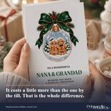 A festive white personalised nana and grandad christmas card with green ribbon bow and glass bauble gingerbread design