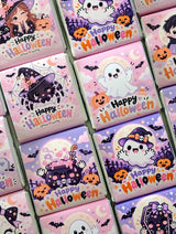 Pink and purple mini neapolitan chocolates with halloween cartoon ghosts witches and pumpkins on colorful wrappers
