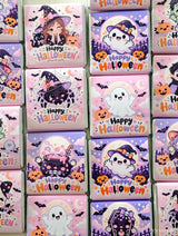 Pink and purple mini neapolitan chocolates with cute halloween monsters like witches ghosts and pumpkins saying happy halloween