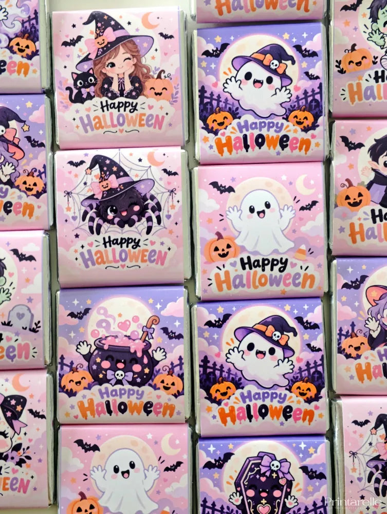 Pink and purple mini neapolitan chocolates with cute halloween monsters like witches ghosts and pumpkins saying happy halloween