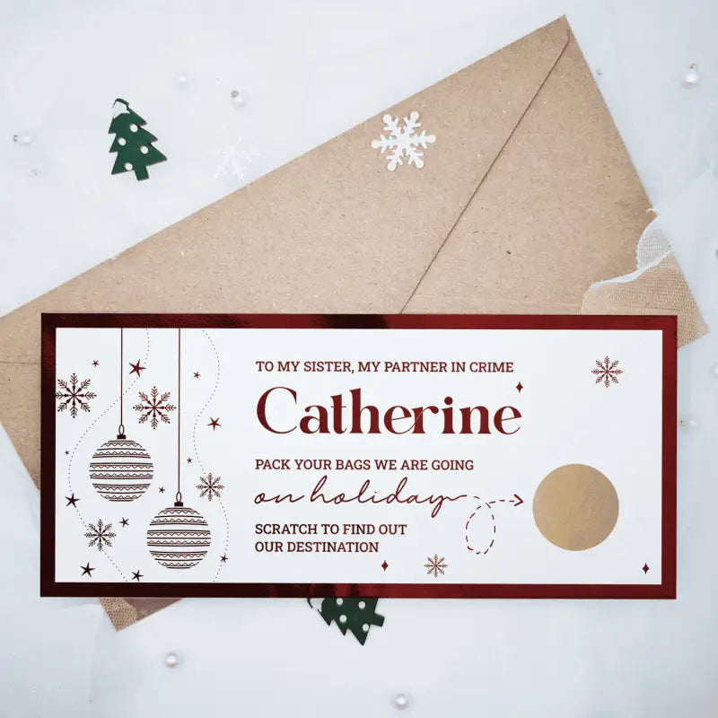 Greeting card with Christmas ornaments and envelope on a snowy background