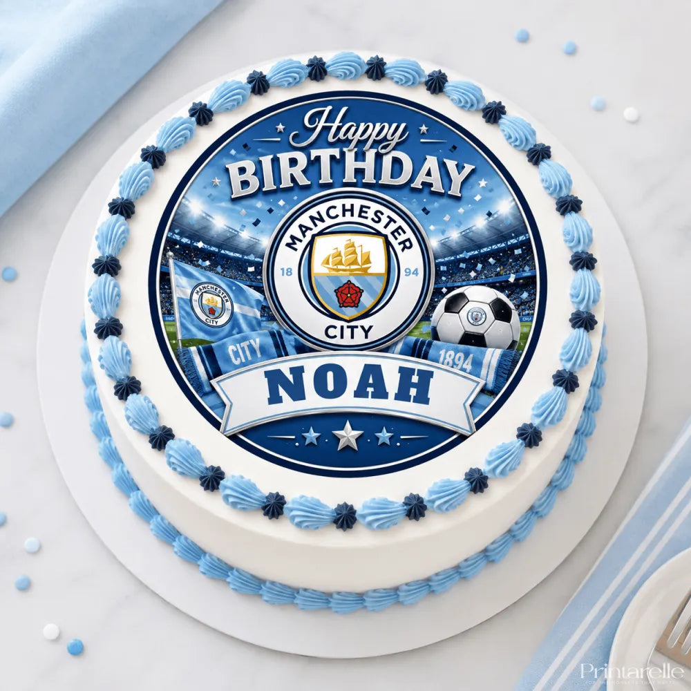 A round white cake with blue scalloped frosting and a manchester city edible icing sheet cake topper with noah banner