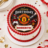 A round white birthday cake with a red frosting border and a manchester united edible icing sheet cake topper featuring the team logo and soccer ball