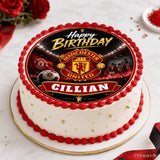 A white birthday cake with red frosting and gold sprinkles topped with a manchester united edible icing sheet cake topper
