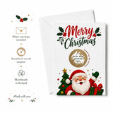 White merry christmas scratch reveal card with cute santa holding gift beside decorated tree and merry christmas text