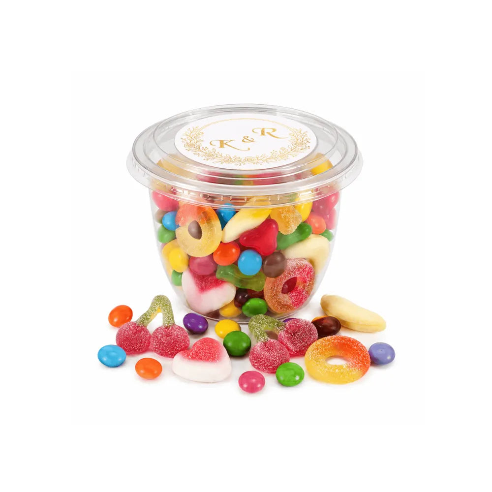Clear plastic container of colorful gummy candies with white lid featuring gold monogram wreath foiled sticker